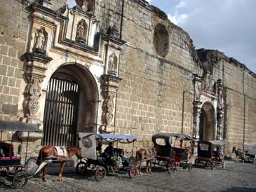 Horse-drawn taxis in the cobble streets of Guatemala